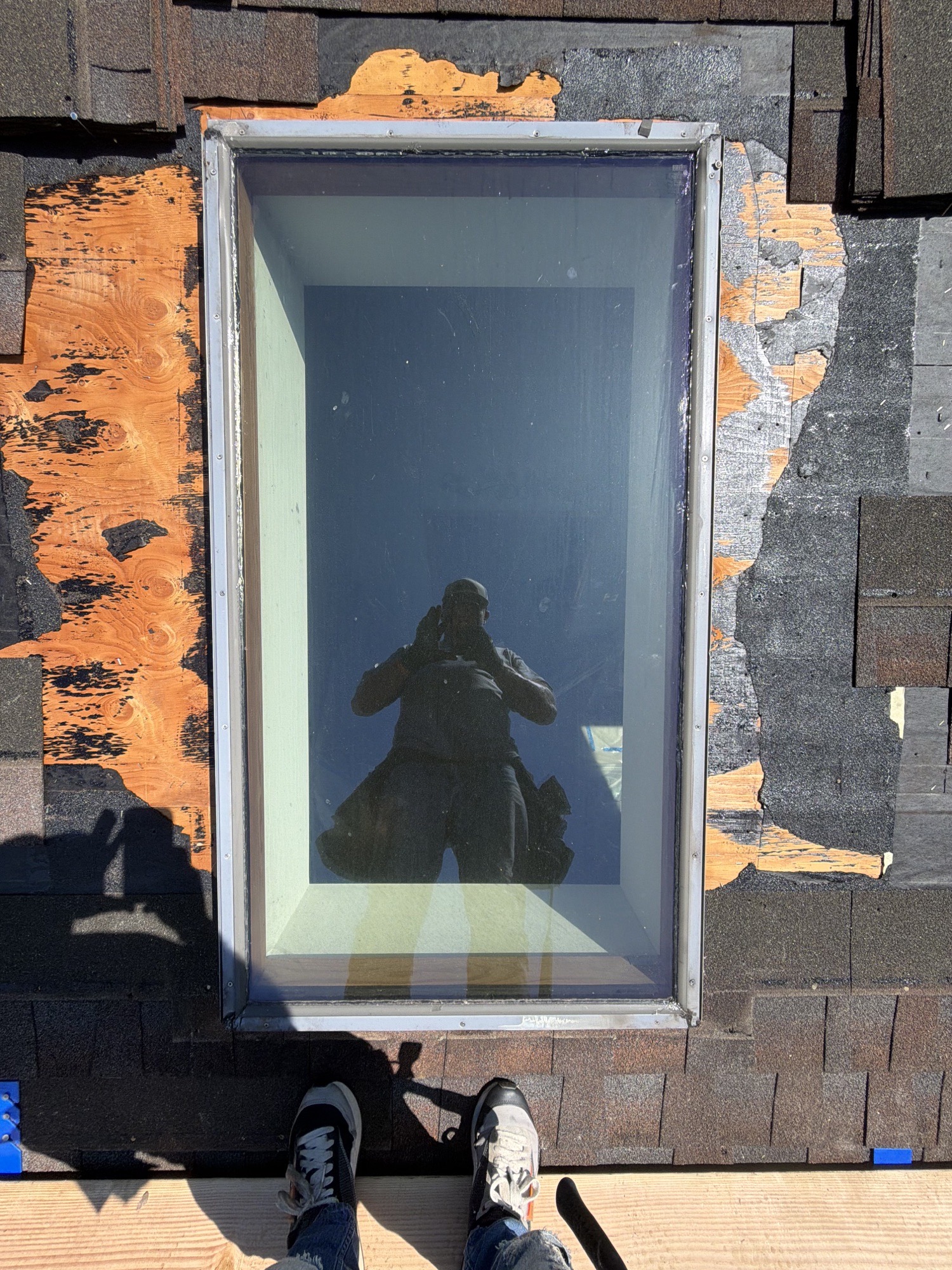 Roof deck exposed around an existing skylight during replacement in Batavia, NY