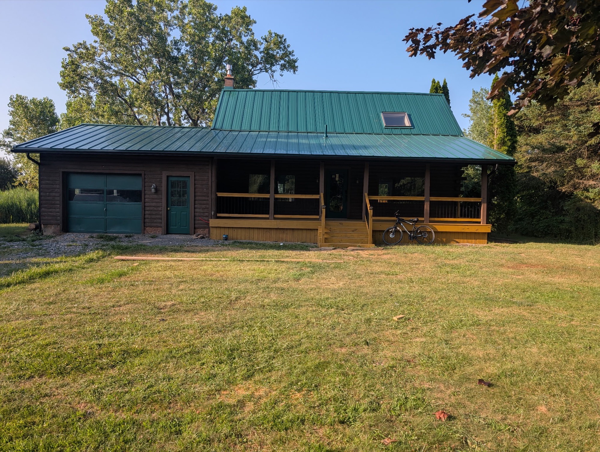 Front of Pembroke home after green metal roof and porch restoration