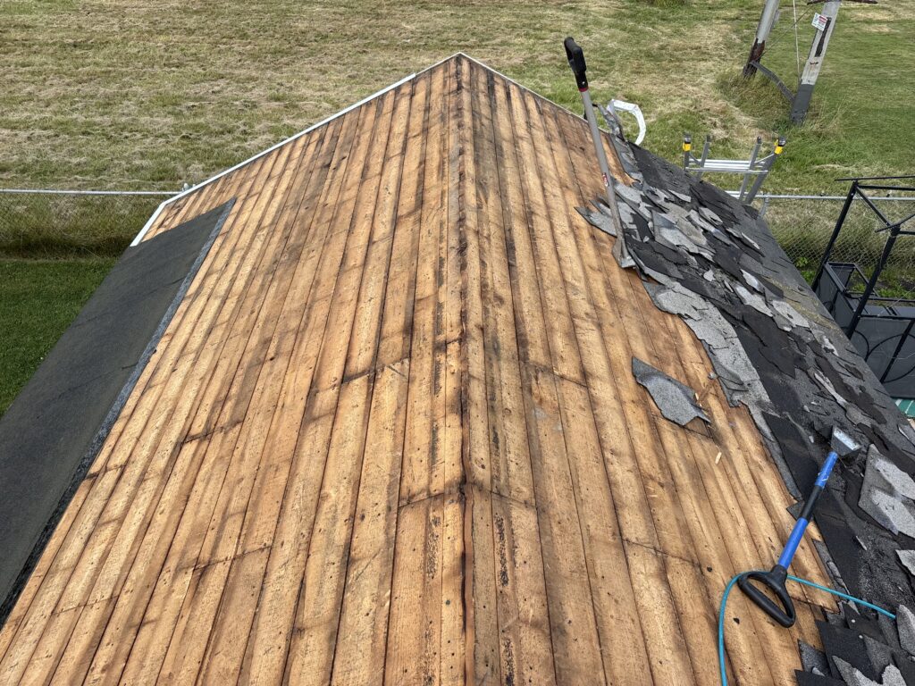 Roof decking exposed during an asphalt-shingle tear-off in Wyoming, NY.