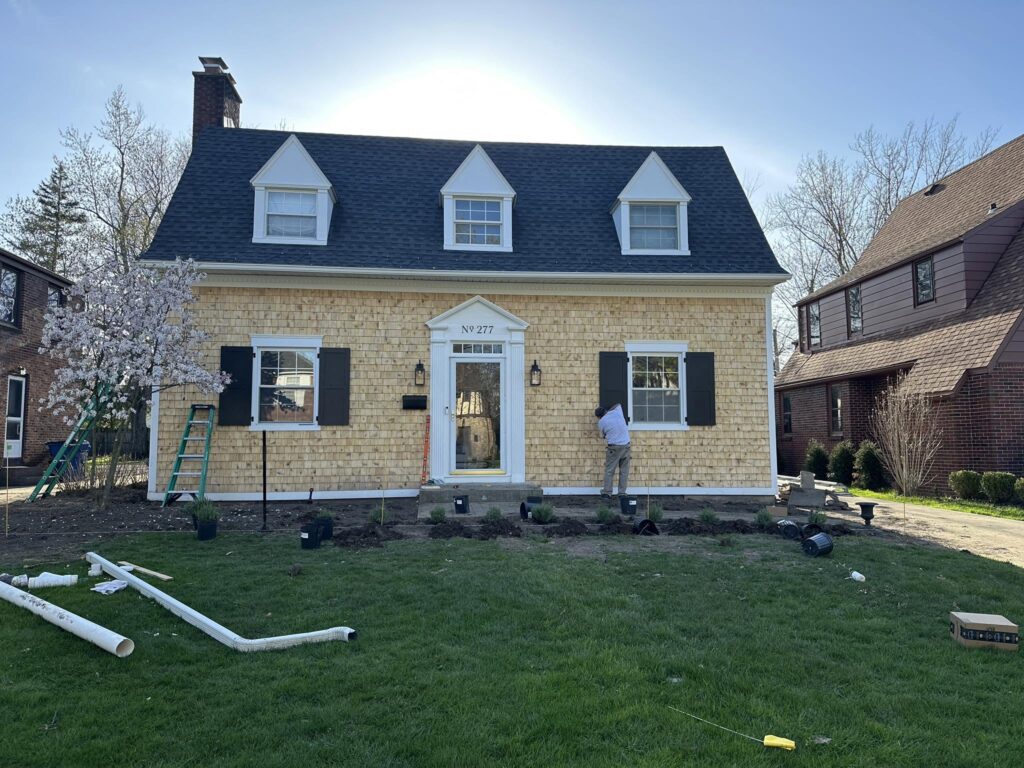 Cedar shake home with a completed asphalt-shingle roof in Erie County, NY.